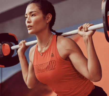 athletic person performing a barbell squat