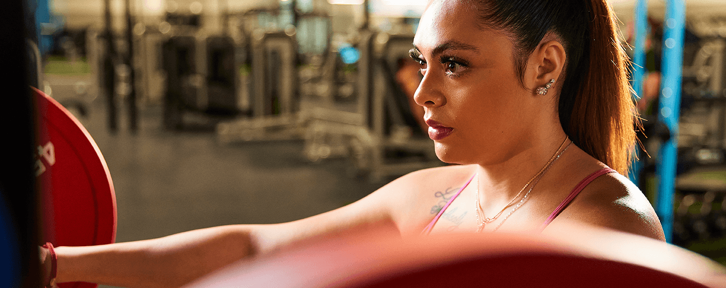 closeup shot of a focused eos gym member about to unrack a barbell to perform a squat