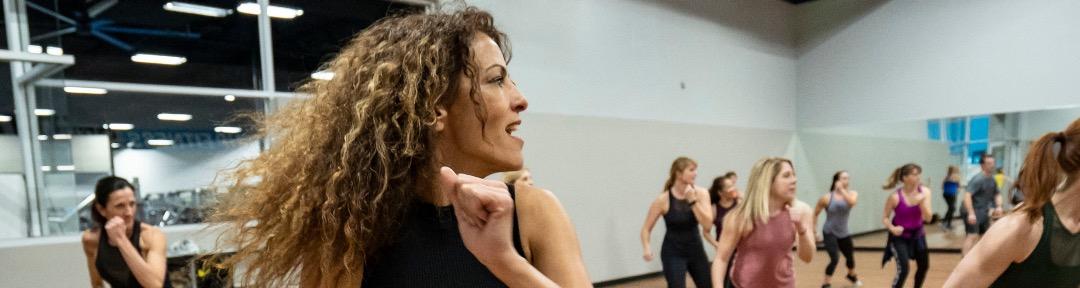 eos fitness instructor leading a group dance class 