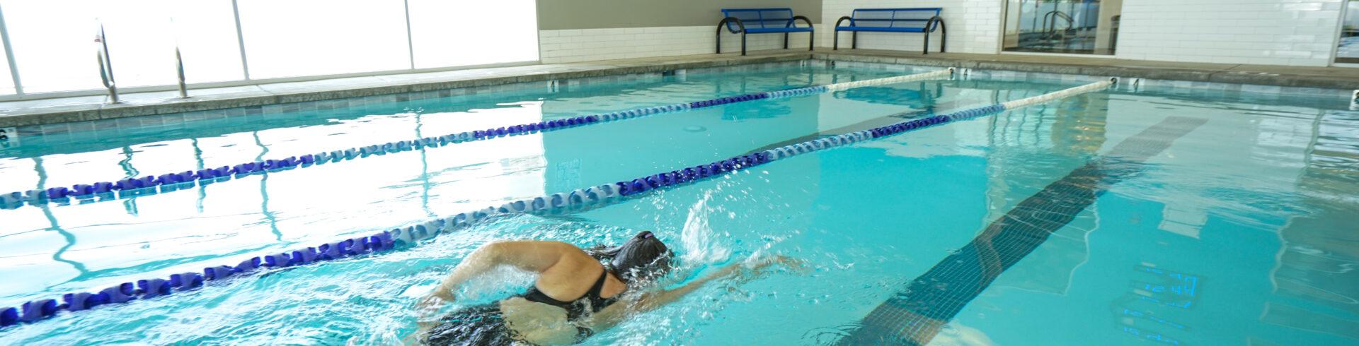 eos member swimming in a clean eos branded lap pool